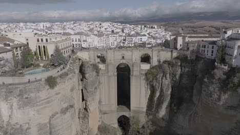 aerial ascends over ronda spain and medieval arch bridge over gorge