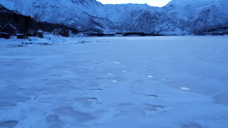 frozen icy fjord in norway - low flyover, harsh winter landscape