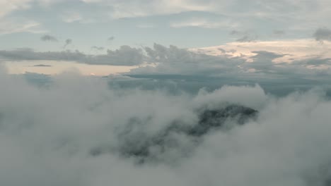 Drone-aerial,-beautiful-misty-cloudy-landscape,-over-a-cloud-forest-in-Guatemala