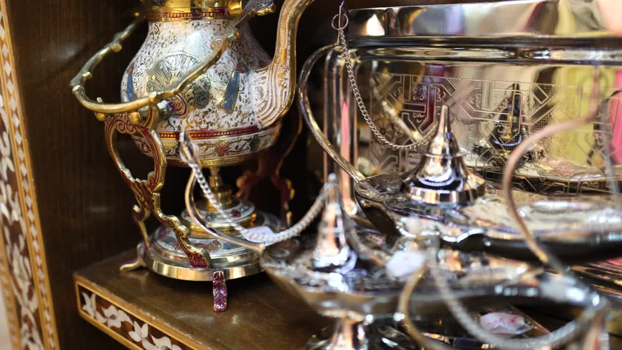Close-up of ornate Arabic lamps and teapots