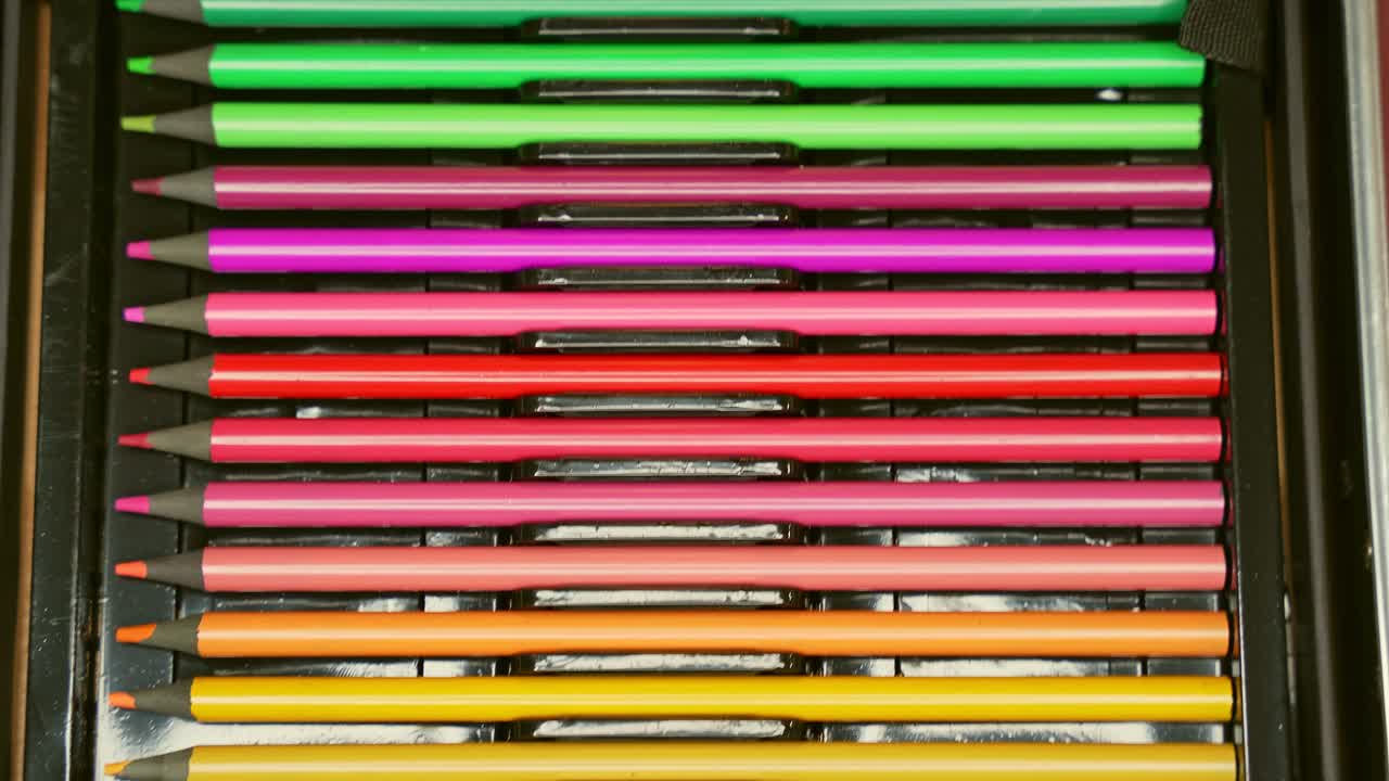 Macro closeup of colorful pencils neatly arranged in rows, symbolizing creativity, education, precision, and artistic tools
