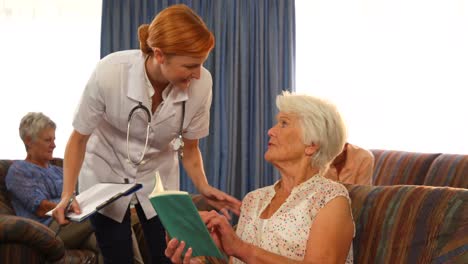 female doctor talking to senior people