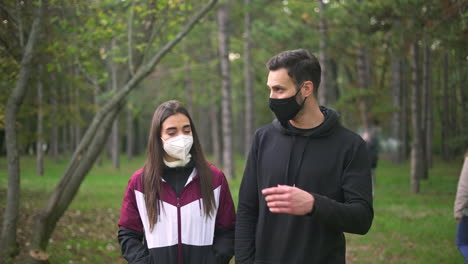 people wearing face masks in the forest
