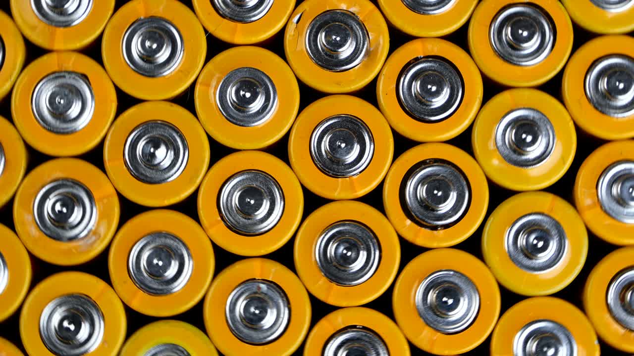 Many used AA alkaline batteries, finger batteries in heap ready for recycling. Harmful effects of planet Earth.