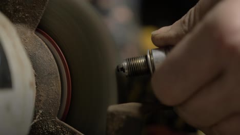 Cleaning-spark-plug-using-bench-grinder