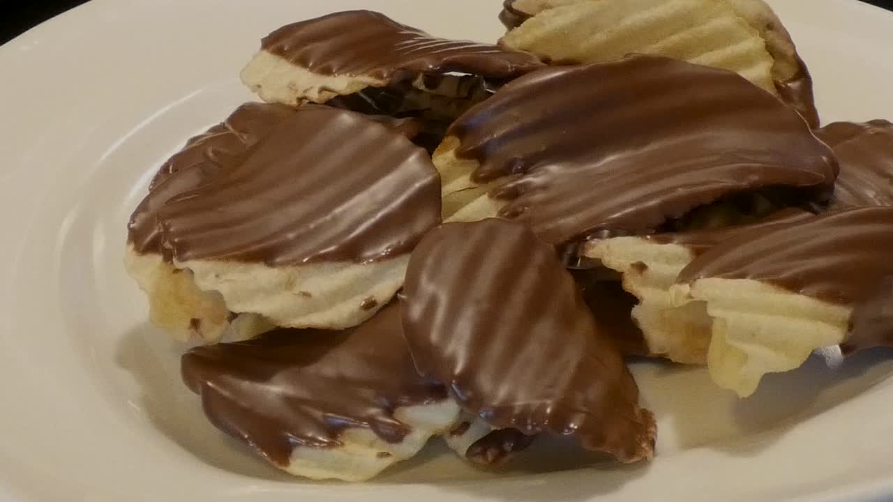 Slow pan over a plate of chocolate-covered potato chips.