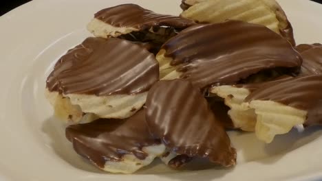 slow pan over a plate of chocolate-covered potato chips.