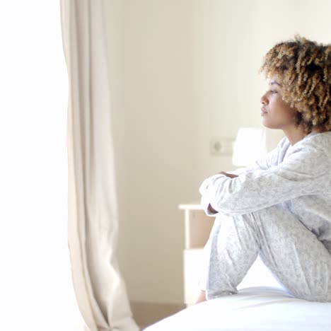 Sad-Woman-Sitting-On-The-Bed