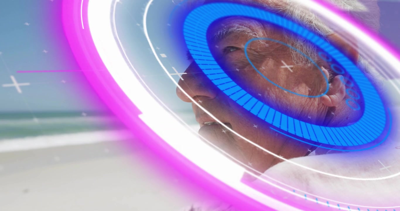 Senior man gazing beach, magenta ring fading then rotating with pulsing HUD technology scanning