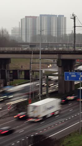 fast timelapse shows blurred cars and trucks streaking along multilane ring road under grey urban sky