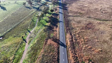 drone footage of rural road through grassy australian landscape