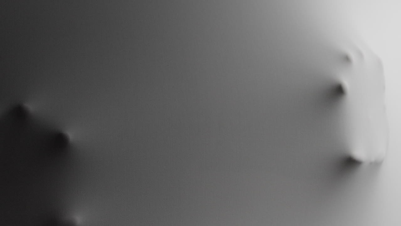 A scary face and hands appear from the white surface