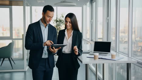business colleagues collaborating with a tablet in a modern office