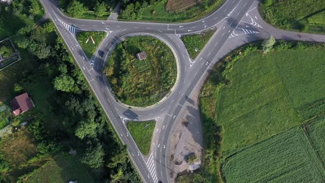 roundabout traffic of cars and trucks on the circle ring road aerial top view.