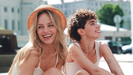 two women friends laughing outdoors