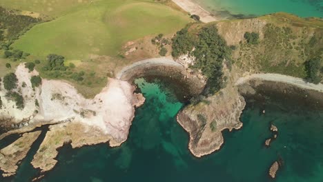 drone flying over limestone cliffs of crayfish bay in new zealand's north island