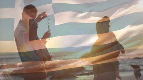 watching sunset at beach, people relaxing with greek flag animation overlay