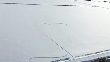giant-heart-made-in-field-with-snowmobile-tracks-during-covid-times
