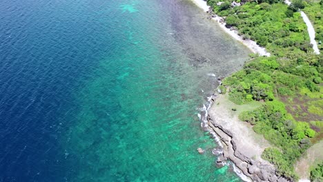 aerial view over a beautiful tropical rocky coastline in philippines, drone flying above the coral reef and turquoise sea, travel concept