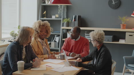 group of diverse colleagues cooperating on business meeting