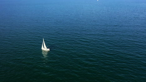 lonely sailboat on a calm ocean