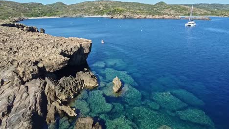 Tranquil-coastline-location,-rock-formations,-still-ocean-water,-aerial