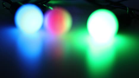 shimmering three multi-colored lanterns on a dark background