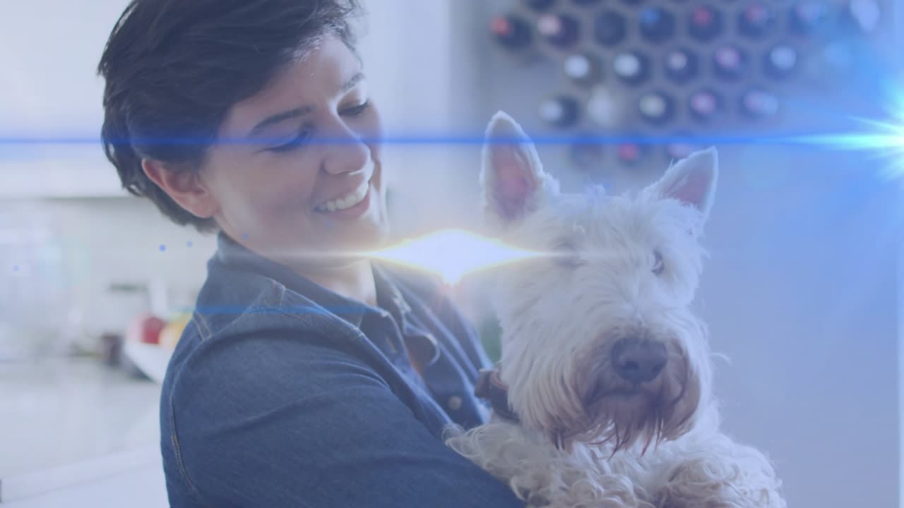 Opening shot showing woman cradling terrier dog at counter showcasing pet care, lens flare sweeping