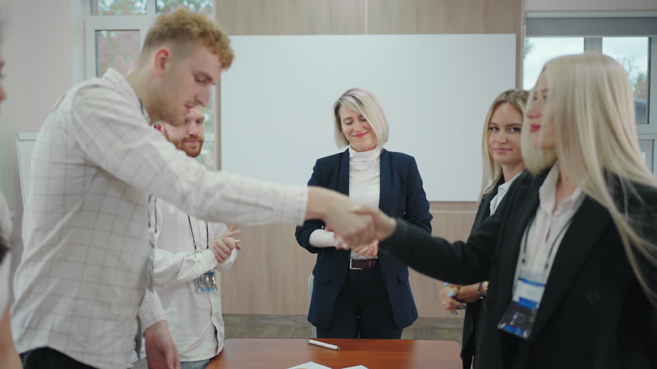 Premium stock video - Specialists of two business team are shaking ...