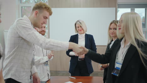 specialists of two business team are shaking hands in conference hall successful negotiation