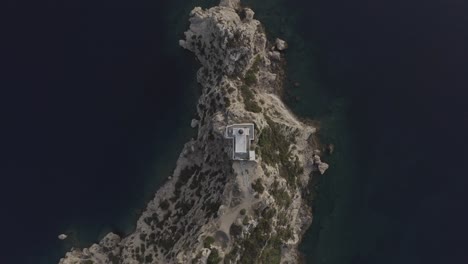 a birds eye view of a lighthouse, somewhere in greece