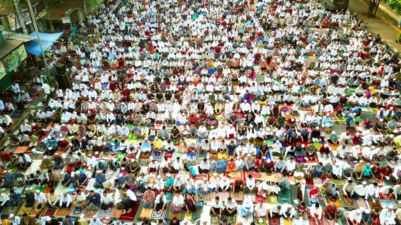 Muslim people praying together outdoors