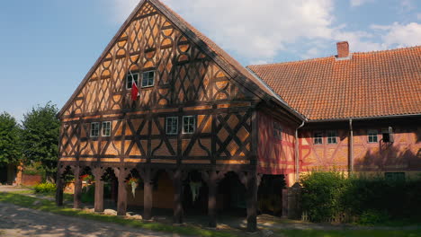 Aerial-shot-of-Charming-Mennonite-arcade-house-in-Poland's-historic-town,-a-glimpse-of-timeless-architecture-drone-flying-right