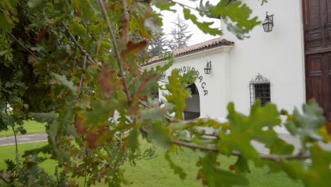 handheld truck right of the arch of the facade of the undurraga winery, one of the most famous wineries in chile