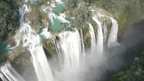 Drone-establishes-grand-cascades-of-water-from-strong-flowing-stream-of-Tamul-Waterfall,-Mexico