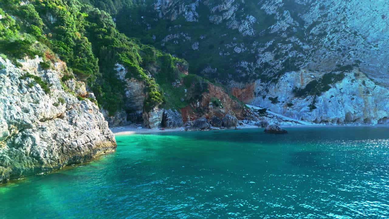 Scenic aerial over Kefalonia's mountains meeting the clear Ionian coastline