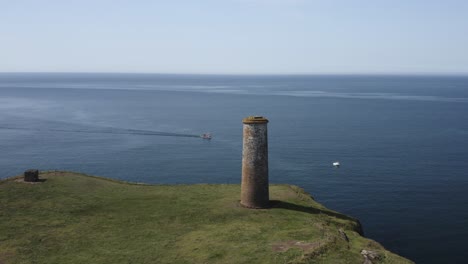 boats slowly motor past guide tower marking entrance to protected bay