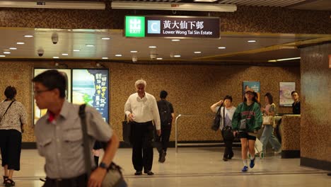 crowd moving through a bustling train station