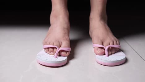 woman wearing pink flip-flops