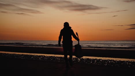 man running with guitar in back sand beach at sunset-5