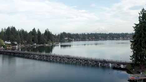 Flying-Over-Lake-Steilacoom-Interlakken-Bridge-With-Mt