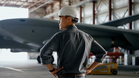 engineer looking at an airplane in a hangar