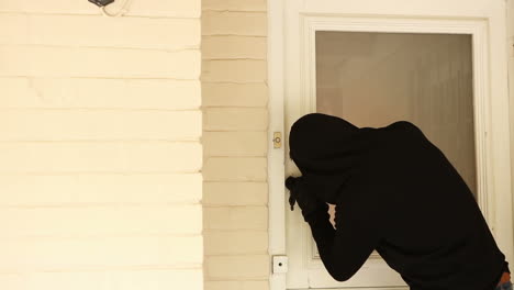 burglar breaking open the door