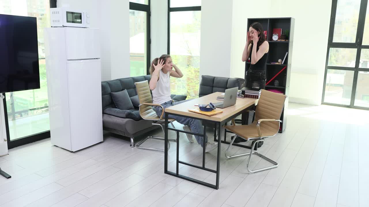 Two women in a living room, possibly arguing