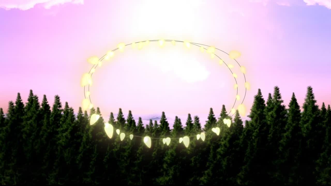 Animation of fairy light frame with copy space over fir trees and winter scenery