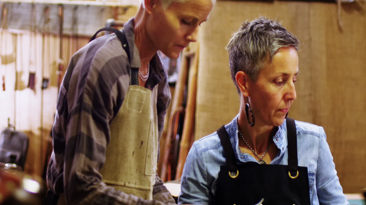 Craftswomen discussing over a thread