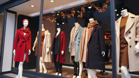 stylish fall fashion display in a shop window