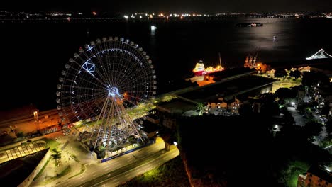 night panoramic landscape of illuminated ferris wheel at rio de janeiro brazil