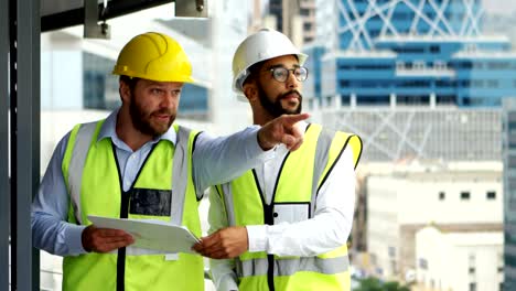 architects discussing over blueprint 4k