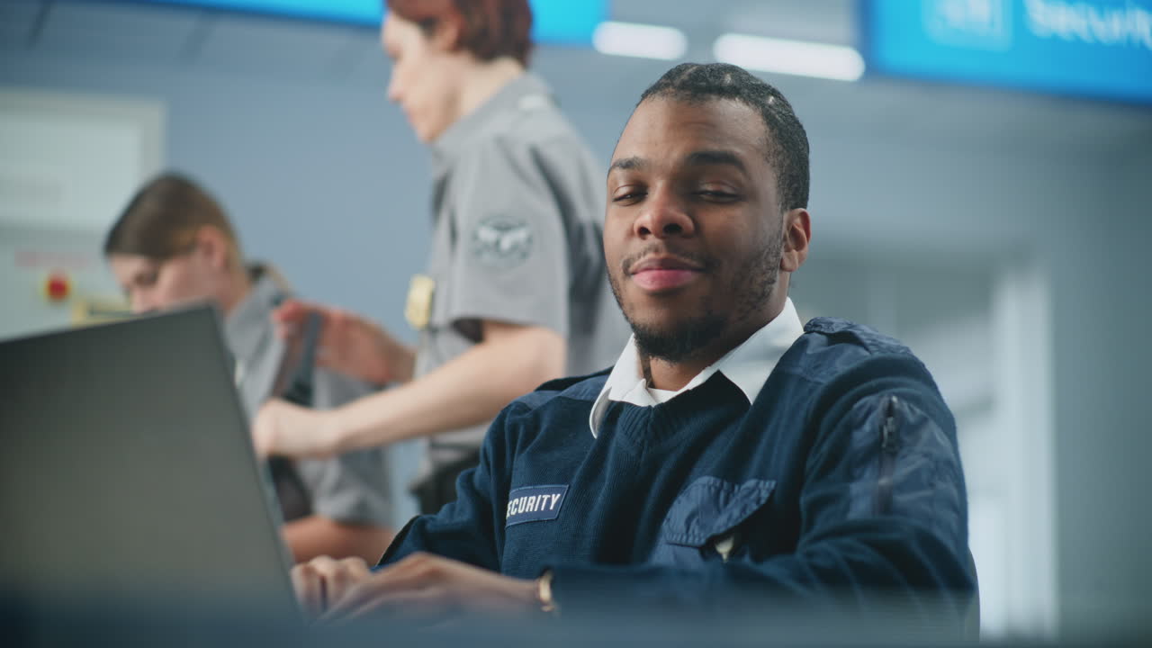 Airport Security Guard Working on a Laptop